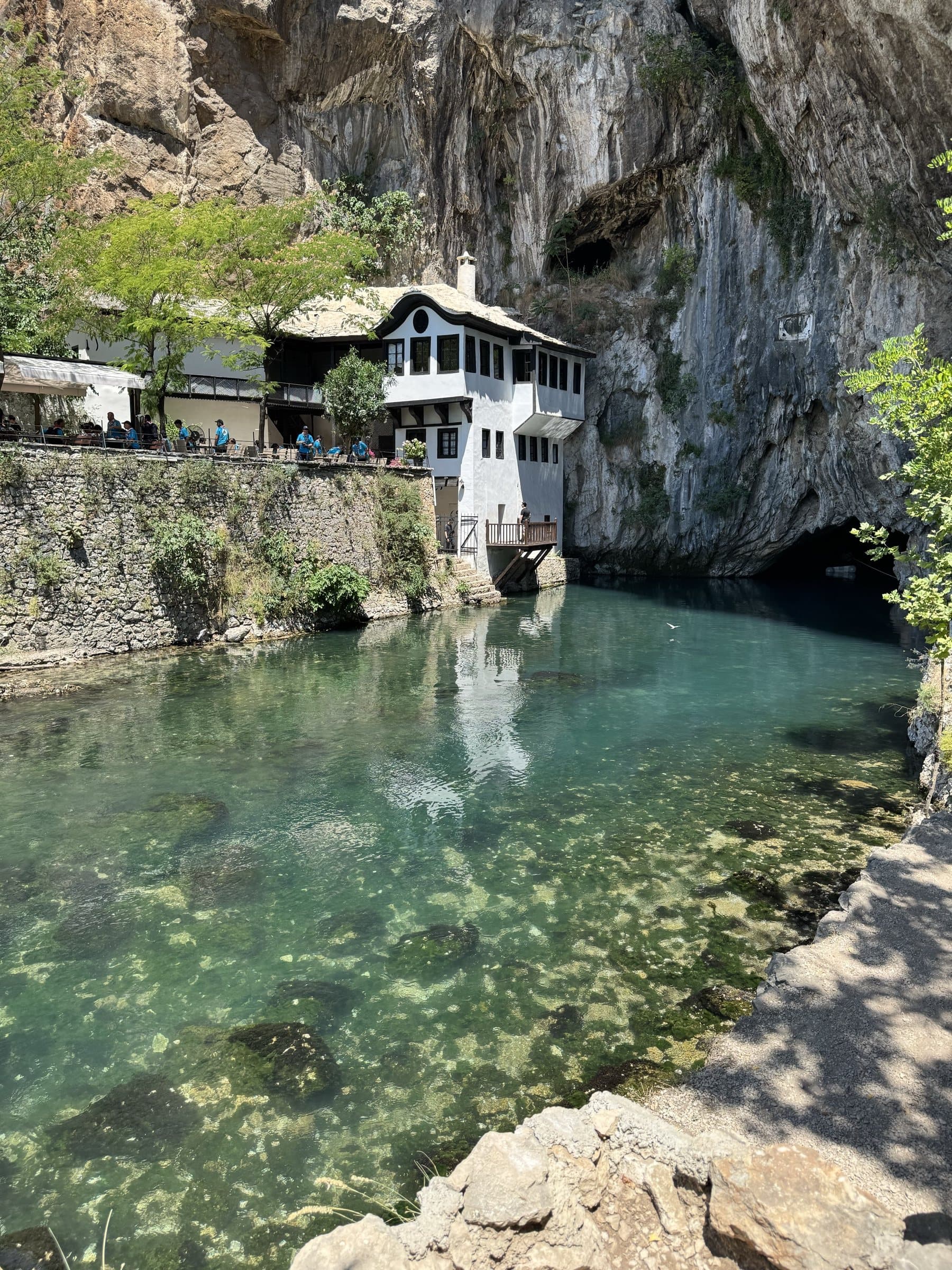 The whitewashed dervish house at Blagaj built into the limestone cliff above the turquoise Buna spring